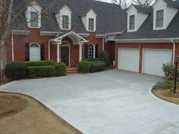 Elegant brick house with manicured lawn and driveway