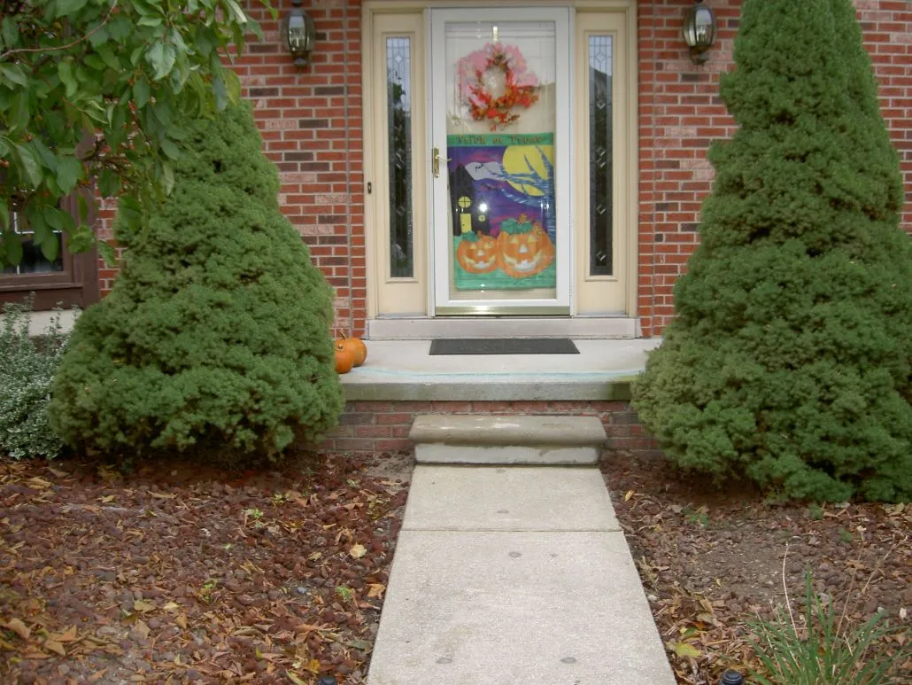 Front porch decorated for Halloween with pumpkins