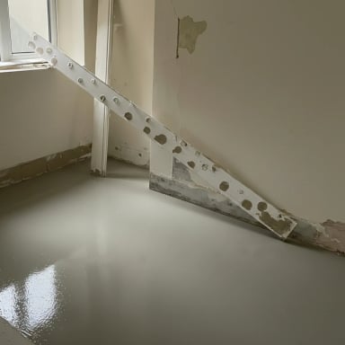 Newly poured floor with construction tools, gray finish